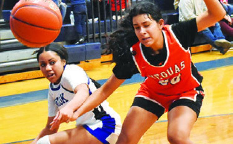 ALANA STRINGFELLOW and Annette Reyna fight for possession of the ball during the Snook-Somerville game last Friday in Snook. Tribune photo by Roy Sanders