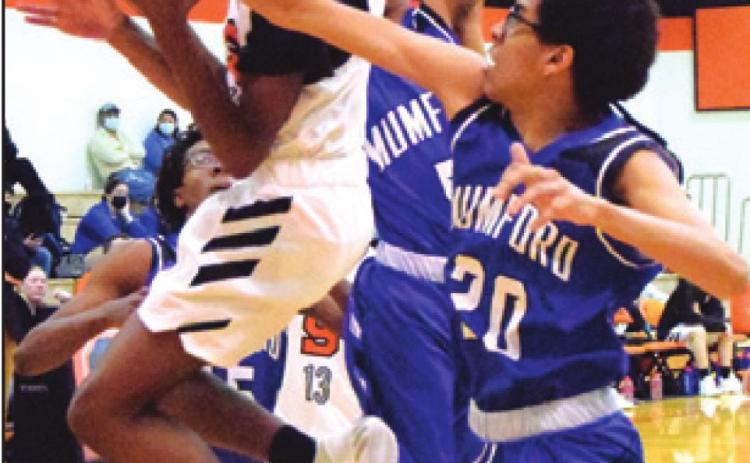 BRANDYN CARTER is fouled by Mumford’s Desmond Gamble while trying to shoot the ball during the Somerville-Mumford game last Tuesday. -- Tribune photo by Denise Squier
