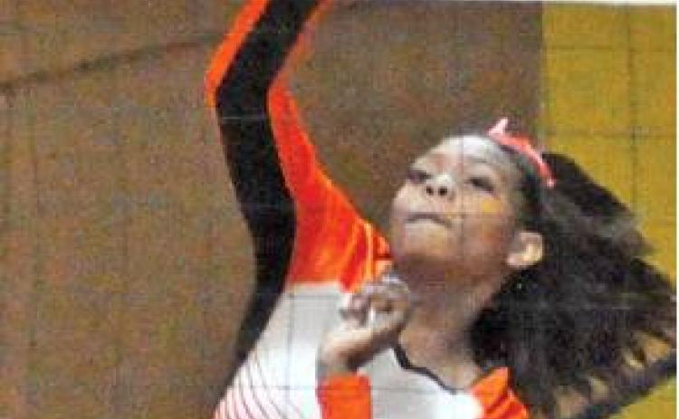 XADRIA MARTIN HITS hits the ball over the net during Somerville’s win over Dime Box on Friday. -- Tribune photo by Roy Sanders