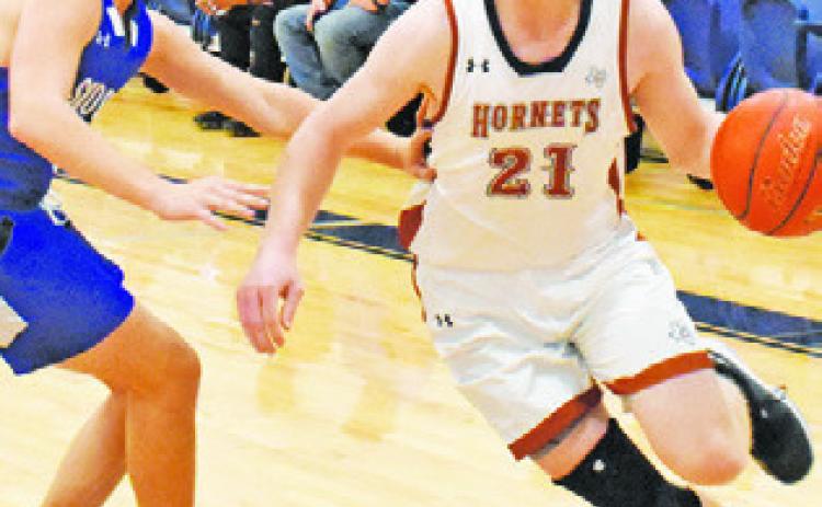 HARRISON NOVAK of Caldwell dribbles the ball as Caden Schluens defends for Snook.