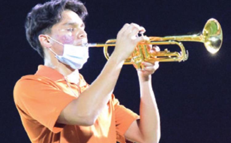 CALDWELL HIGH SCHOOL drum major Adolfo Gaucin plays a trumpet solo during the Caldwell-Academy halftime show on Friday.