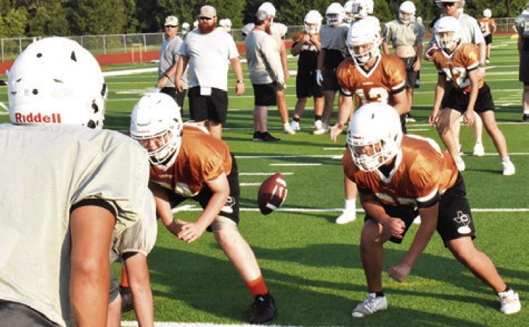 THE CALDWELL HORNETS work on their offensive plays in this practice session. -- Tribune photo by Roy Sanders