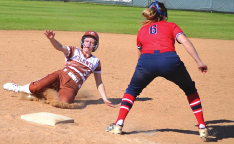 CALDWELL’S EMERSON FAUST slides into third base during the Lady Hornet’s 8-8 tie with Madisonville on Saturday during the annual SWARM Tournament at Lady Hornet Field in Caldwell.