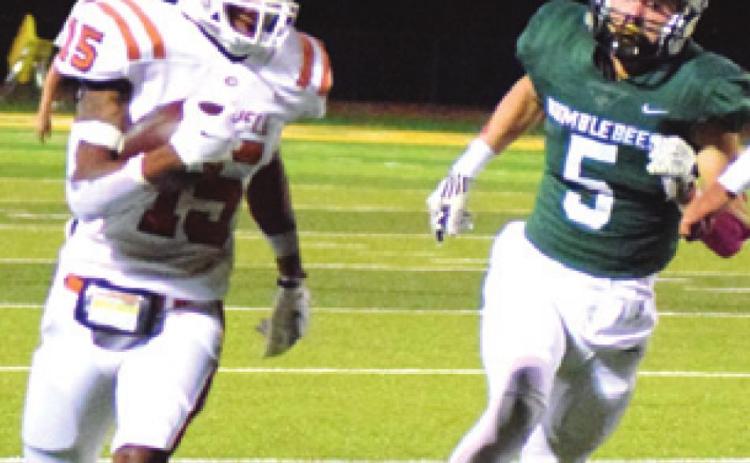 CALDWELL’S LARRY DAVIS gets away from Bumblebee defender Scout Brazeal during the Hornets’ loss to Little River Academy Friday night. -- Tribune photo by Denise Hornaday