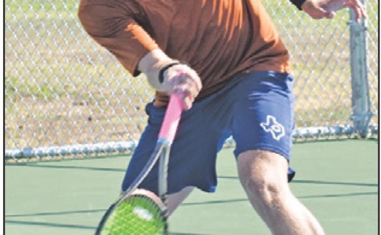WAYLON CHAPMAN returns serve during the Caldwell-Cameron Yoe match last Thursday. — Tribune photo by Roy Sanders