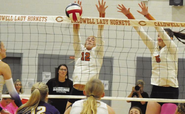 CALDWELL’S ABBY VOGLER blocks a hit from a La Grange player during the Caldwell-La Grange match on Friday. Tribune photo by Denise Squier