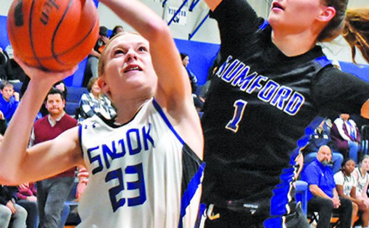 SNOOK’S DAKOTA Kienow attempts to shoot the ball while Mumford’s Allison Scamardodefends. -- Tribune photo by Roy Sanders