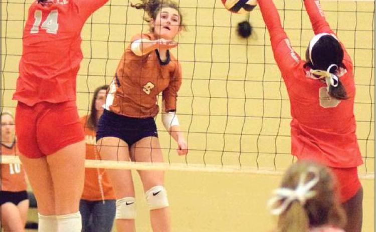 CALDWELL’S CORINNE DILLARD gets a kill during the Lady Hornets’ tie-breaker seeding match against Bellville on Friday night in Giddings. Bellville won the match and earned the top seed from District 26-4A for the UIL Class 4A Volleyball Playoffs which began this week.