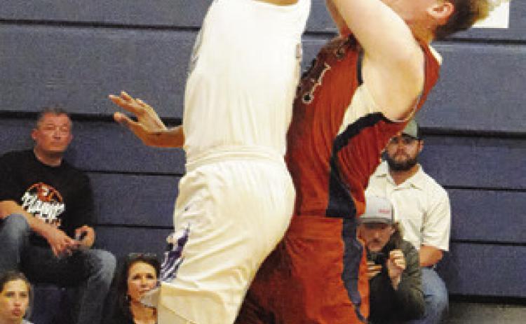 HARRISON NOVAK of Caldwell takes a shot as this Wheatley defender reaches to block it. -- Tribune photo by Denise Squier