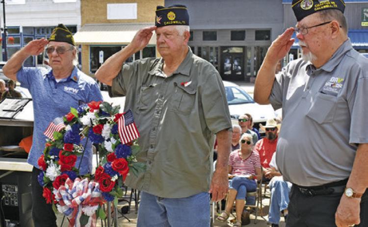 THE MEMORIAL DAY Wreath is placed on Monday at Memorial Day. Pictured from left are Henry Probst, Donny Wood and John Mayson.
