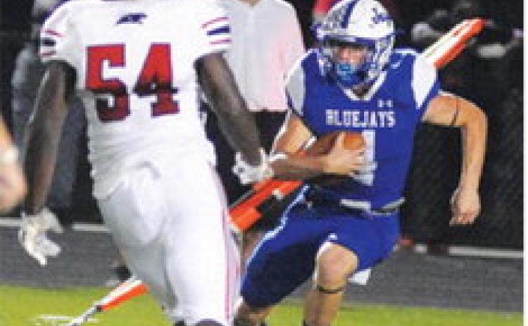 GARRETT HYVL returns this kickoff for a touchdown. -- Tribune photo by Denise Squier