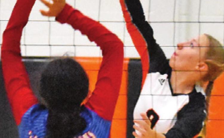 ABIGAIL FLENCHER hits the ball over Royal’s Stephanie De La Rosa during Somerville’s win Friday. -- Tribune photo by Roy Sanders