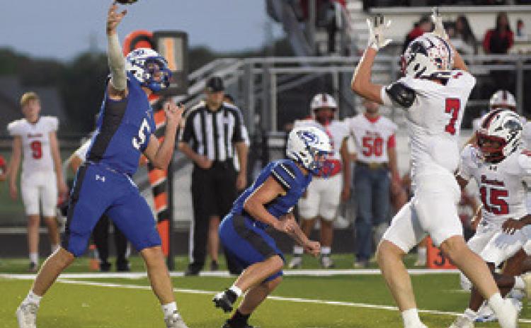 BRAYDEN MACIK OF Snook hurls this pass against Burton. Tribune photo by Kim Hutcheson