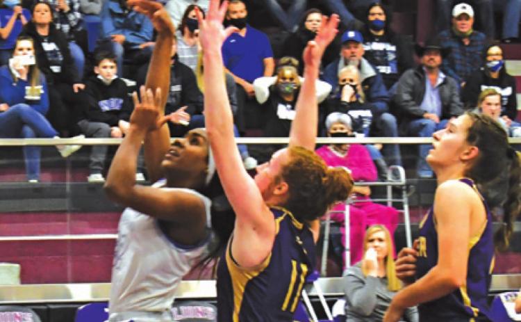 SNOOK’S JAIVAN STRINGFELLOW puts up a layup while Shiner’s Emma Herman defends during the Lady Jays’ area win over the Lady Comanches. -- Photo courtesy of Mark Lube of The Shiner Gazette