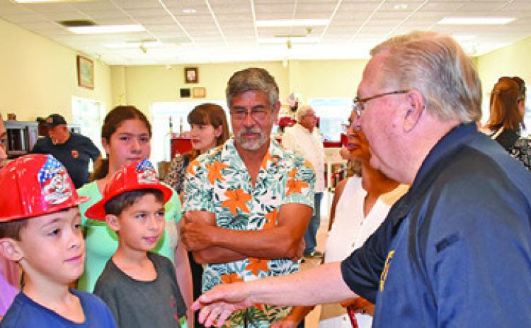 CALDWELL FIRE CHIEF Harry Bowers greets visitors on July 22 at the fire station during the 140th anniversary celebration. Tribune photo by Roy Sanders