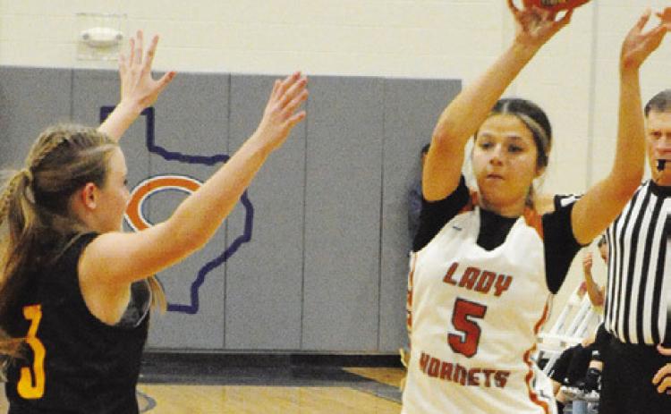 CALDWELL”S ASHLYN KELLUM passes the ball while Thorndale’s Jordyn Smith defends during the Lady Hornet-Lady Bulldog game last Friday night at Hornet Gym. -- Tribune photo by Denise Squier