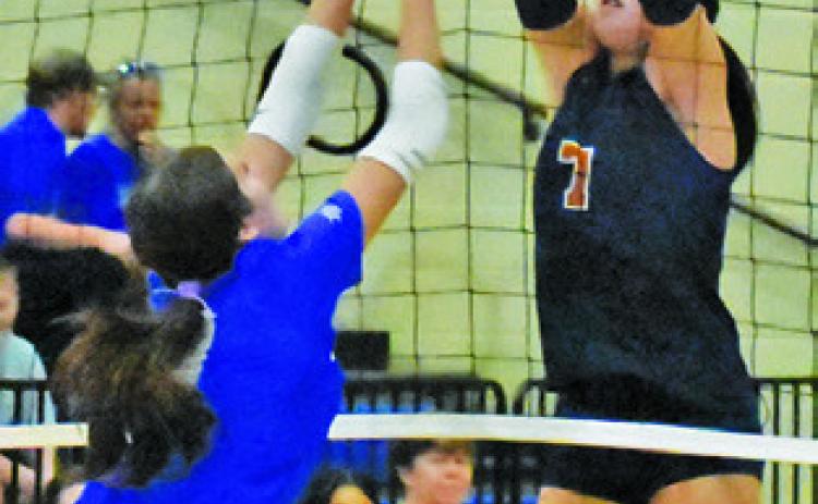 CLOEY RUSS goes up to block the ball during the Caldwell-Rockdale match last Friday. Tribune photo by Roy Sanders