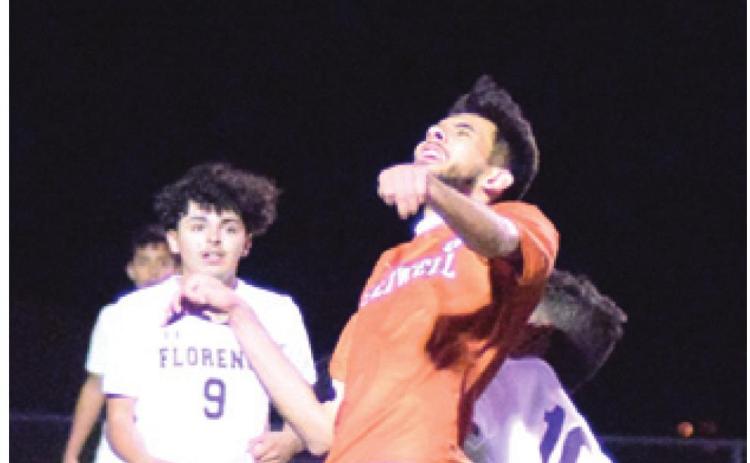 ELY RIVERA heads the ball during the Caldwell-Florence game last Tuesday night in Caldwell. -- Tribune photo by Denise Hornaday
