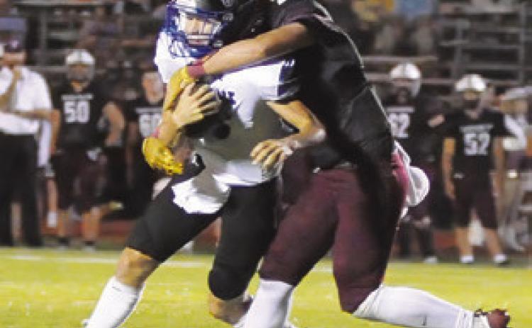 SNOOK QUARTERBACK BRETT Withem is tackled by a Tarkington defender. Tribune photo by Denise Squier