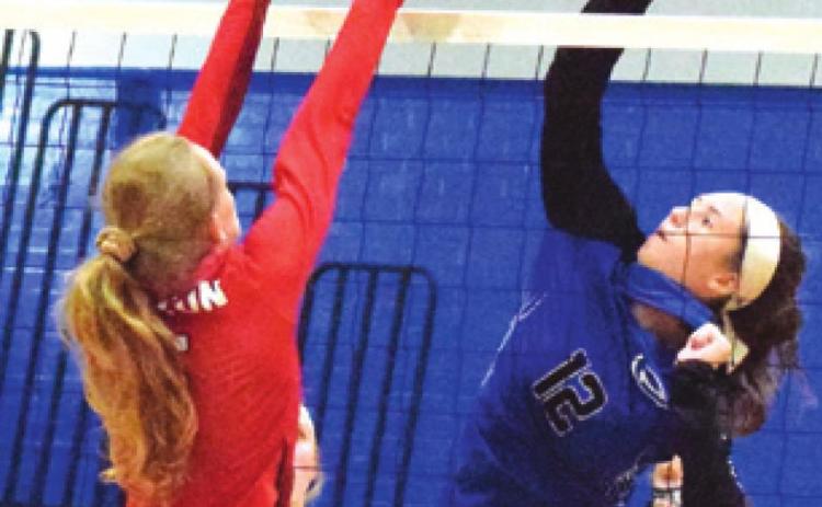 SNOOK’S RILEY GREEN HITS the ball over Burton’s Allie Hohlt during the Lady Jays’ win over the Lady Panthers in five sets.