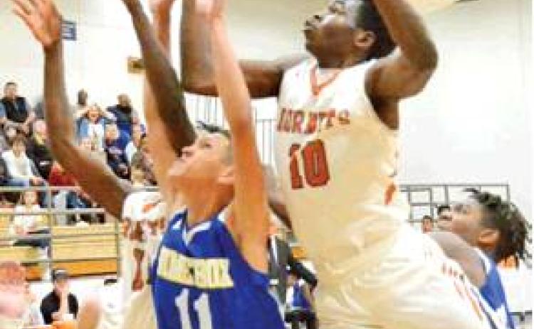 DONOVAN JABBAR of Caldwell leaps high for this rebound against Dime Box last Tuesday in Caldwell. The Hornets won 45-44.