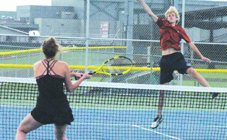 CALDWELL’S BREYDEN ATHEY volleys the ball during a mixed doubles match with partner Hope Savage last week. -- Tribune photo by Denise Squier