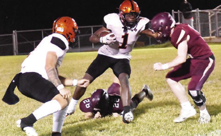 KEITH CRAWFORD CARRIES the ball against Milano. Also pictured is teammate Ian Teague. Somerville won 34-22. Tribune photo by Roy Sanders