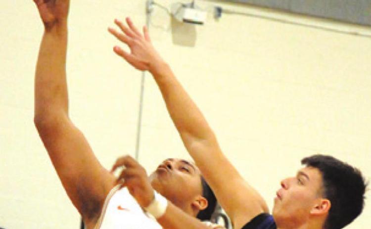DEVLIN MORRIS REACHES for a rebound during the Caldwell-Florence game last Friday night. -- Tribune photo by Denise Squier
