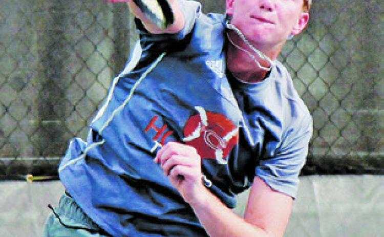 RYAN SEE SERVES to an Academy player during the Caldwell-Academy team tennis match last Monday in Caldwell.