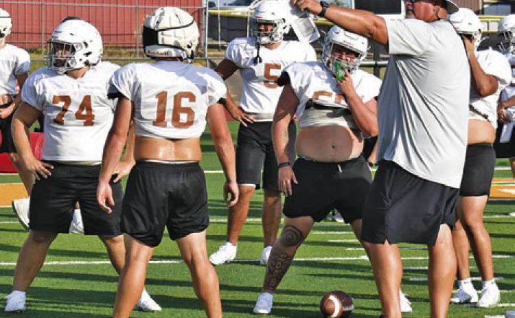 CALDWELL HEAD COACH Sean Witherwax talks to his players during a Monday, Aug. 24, workout at Hornet Stadium. Tribune photo by Roy Sanders