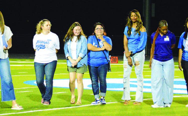 SNOOK’S 2011 AND 2012 state champion girls track teams were recognized on Friday at the Snook-St. Stephen’s football game. Tribune photo by Kim Hutcheson