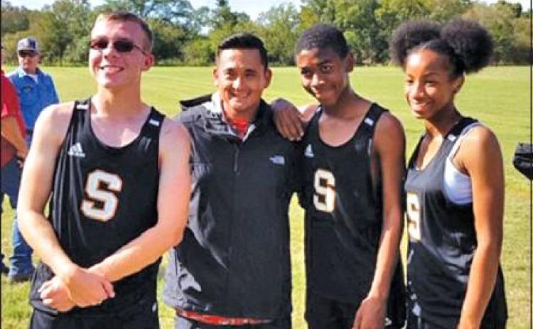 SOMERVILLE’S JARET PINKERTON, Javen Henderson and Ra-Maya Carter ran at the UIL Class 2A Region 4 Cross Country Meet on Monday. They are pictured with Running Yeguas’ coach Billy Ramey.