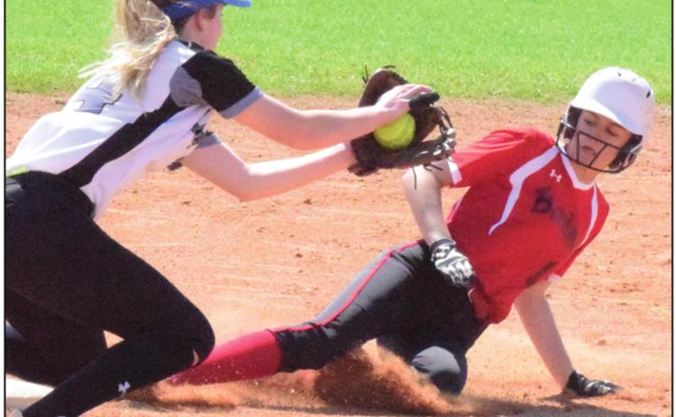 SNOOK’S JAYCIE BRISCO attempts to tag out an Iola runner at third base during a game in mid-March. The UIL recently released the 2020-2021 softball alignments. -- Tribune photo by Denise Hornaday