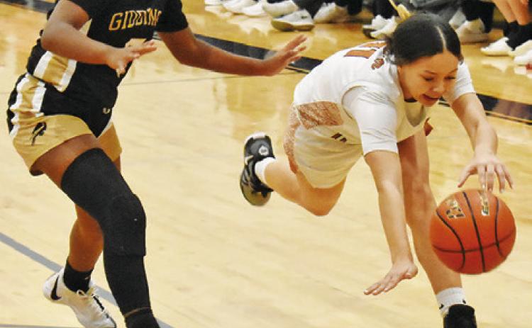 CALDWELL’S CHASSIDY ROGERS chases down the ball during the Lady Hornets’ 50-36 home loss to Giddings on Friday.