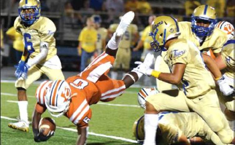 CALDWELL’S NICOLAS JOHNSON dives with the ball for extra yardage during Friday night’s Caldwell-Rockdale football game at Rockdale High School. The Tigers pulled out a 44-36 win despite a good showing from the Hornets. -- Tribune photo by Denise Hornaday