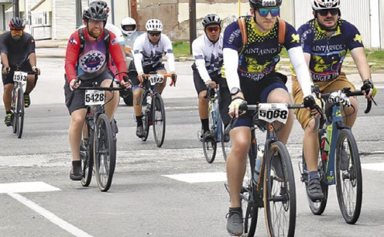 BIKERS FROM THE MS 150 bike ride make their way into Somerville on Sunday, April 28, headed for F.M. 1361 and on to College Station.