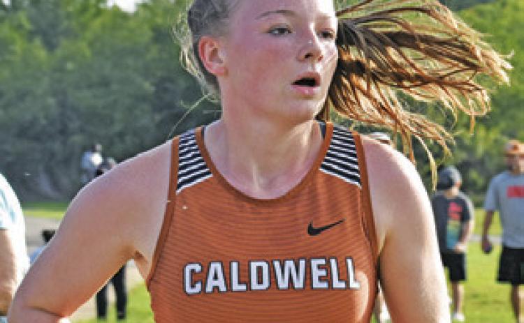 CALDWELL’S CADIE Coston runs during the varsity girls race of the Caldwell Invitational last Saturday at Davidson Creek Park.