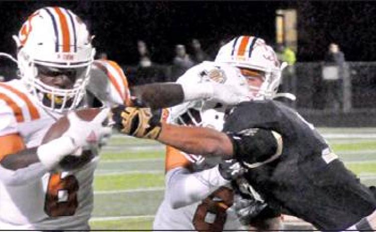 CALDWELL’S NICOLAS JOHNSON moves past this Giddings defender as Logan Knesek assists. The Hornets lost 21-7 in their district opener and face La Grange this week. -- Tribune photo by Roy Sanders