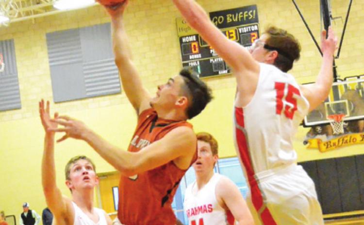 CALDWELL’S BOBBY LEROUAX takes a shot despite some heavy pressure from Bellville defenders last Friday in Giddings. The Hornets won the second-place playoff game 59-53.