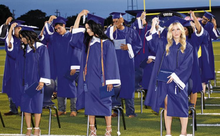 SNOOK HIGH SCHOOL graduates move their tassels on Friday at the commencement ceremony, signifying that they have graduated.