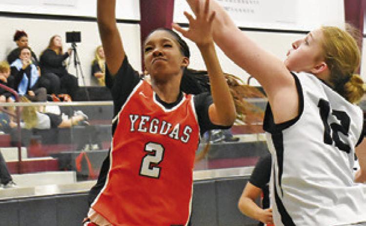 KARYS ELLIS TAKES a shot while a Cornerstone Christian Academy player defends during the Fayetteville Tournament last week. Tribune photo by Roy Sanders