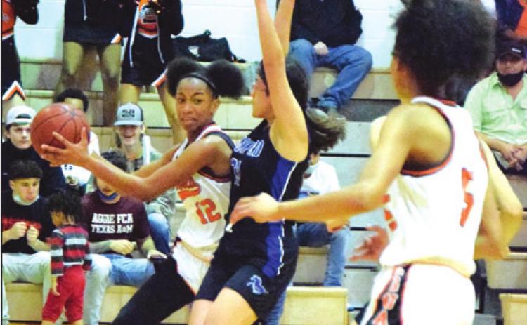 SOMERVILLE’S RA’MAYA Carter looks to pass the ball to Destiny Vela during the Lady Yeguas’ win over Mumford last Tuesday night.