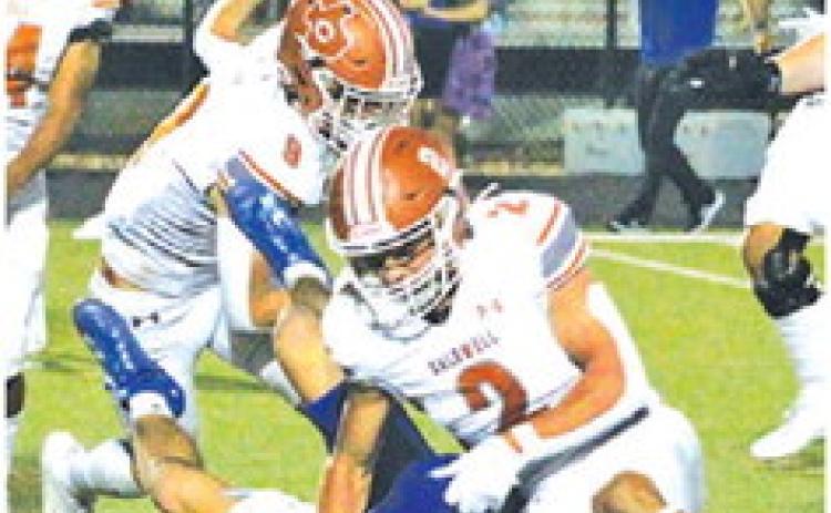 BLANE GARZA OF Caldwell makes a tackle last Friday against the Jarrell Cougars. -- Tribune photo by Kim Hutcheson