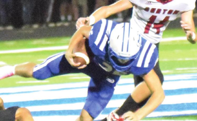SNOOK’S JORDAN PRICE gets tripped up by the Burton defense during last week’s Bluejays’ home game. -- Tribune photo by Denise Squier