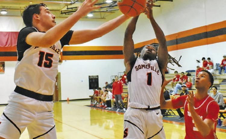 SOMERVILLE’S HERSCHEL CONWAY and Irman Sadic fight fight for the ball against Bellville. -- Tribune photo by Roy Sanders