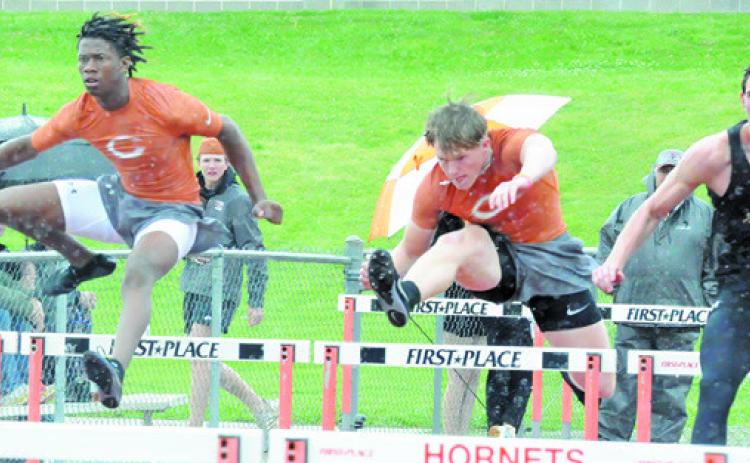 CALDWELL’S JIMMY Kearney and Corbin Stewart compete in boys hurdles at last week’s Happy Skrabanek Relays in Caldwell. See story inside. -- Tribune photo by Denise Squier
