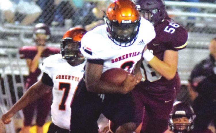 SOMERVILLE’S ARVIS BURNS breaks through the line for a 70-yard touchdown run during last Friday’s Yegua road win over Milano to open district play. -- Tribune photo by Denise Squier