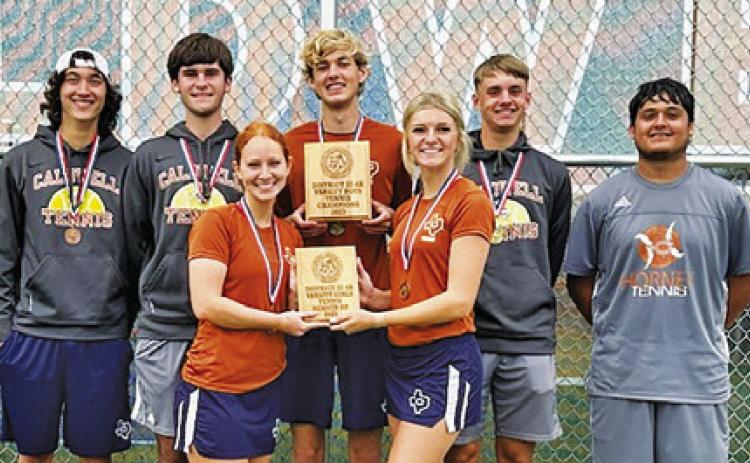 CALDWELL SENIOR TENNIS players proudly display the boys teams’ district champion plaque and girls teams’ district runner-up plaque at last week’s District Tennis Tournament in Caldwell.