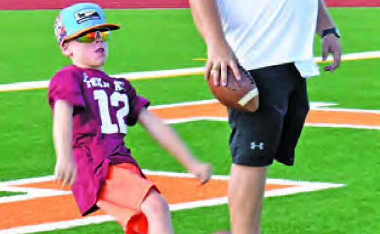 PUNTING SKILLS are taught last Thursday at the Hornet football camp at CHS Stadium.