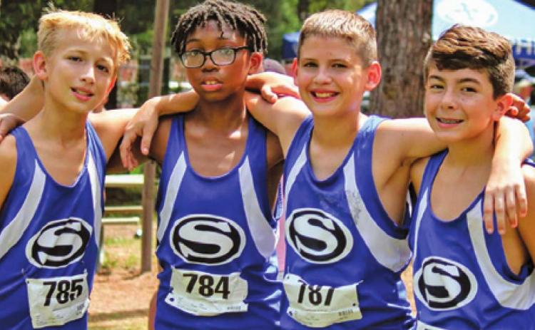 THE SNOOK BLUEJAY cross country team ran at the Cooper Dragon Cross Country Invitational in Tomball last Saturday, Sept. 4. Pictured, from left, are Barrett Dudensing, John Carr, Caiden Gill and Braedyn Fannin. They competed in the sixth and seventh-grade division.